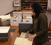 Marie McMillian and Mary Palevsky review Ms. McMillian's donation of test site documents in UNLV Special Collections