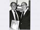 Carl Cohen receiving an award from an unidentified man, 1970s-1986