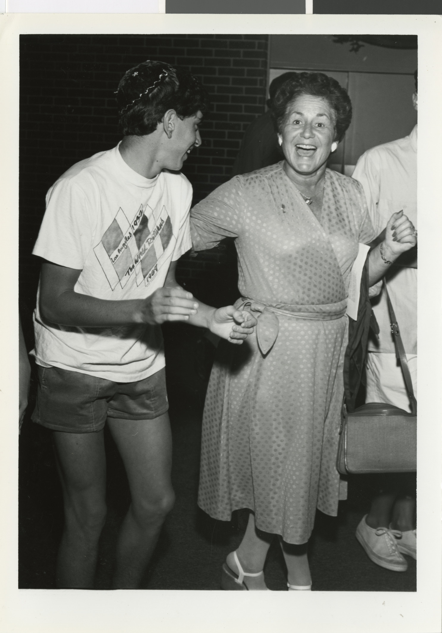 Photograph of Faye Steinberg dancing the "Hora" with U.S.Y., 1980s