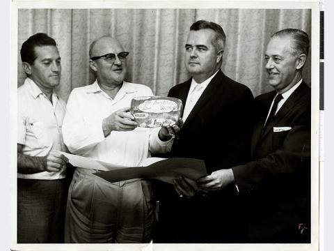 A black and white photo of Al Freeman, unspecified, and three others at the Sands Hotel in Las Vegas, Nevada. The man second fr