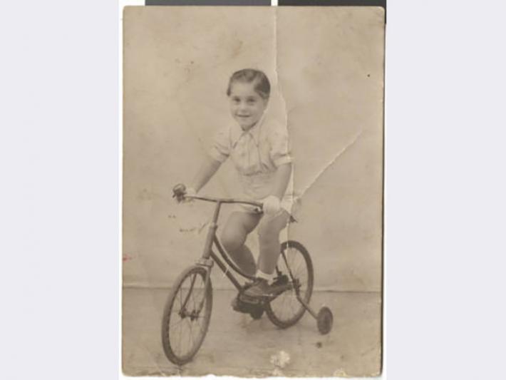 Photograph of Maurice Behar a bicycle, August 24, 1942